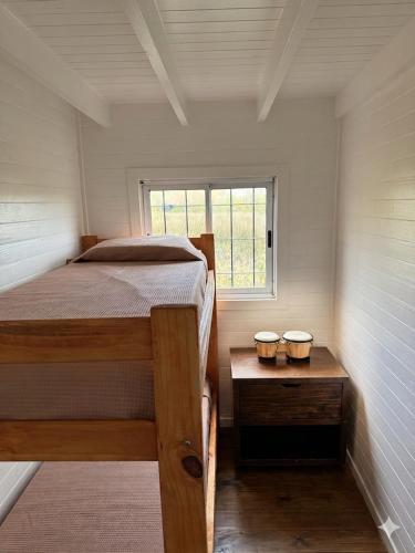 a small bedroom with a bed and a window at Casa Sauce Delta in Tigre