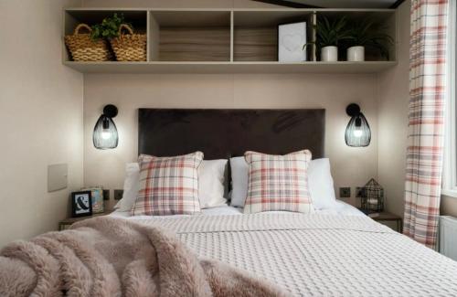 a bedroom with a large bed with two pillows at Hardy's Hut in Felton