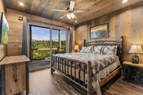 a bedroom with a bed and a large window at Splash N Heavenly Views in Gatlinburg
