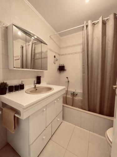 a white bathroom with a sink and a shower at Vue Panoramique Vence Balcon & Calme in Vence