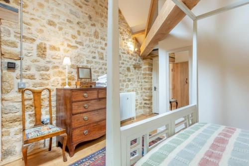a bedroom with a bed and a wooden dresser at 1 Bed in Stoke Abbott oc-35012 in Burstock