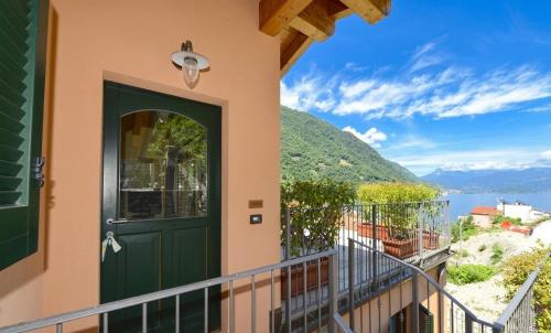 a door to a balcony with a view of the water at NEW Larioview suites in Argegno