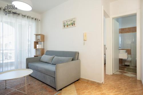 a living room with a couch and a table at Joni's Small Condo in Golem