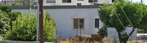 a white house with a fence in front of it at Xrysanthis Kaouris in Limassol