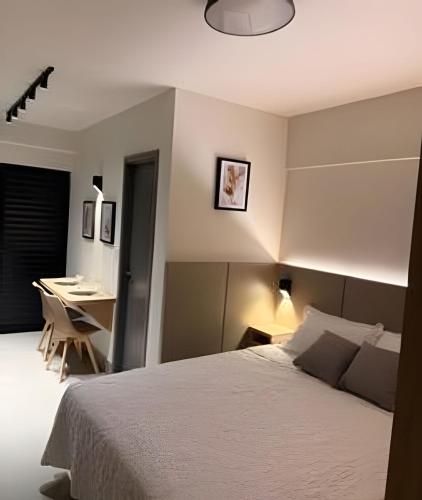 a bedroom with a bed and a desk in it at 818 - Standard Premium in Uberlândia