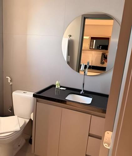 a bathroom with a sink and a mirror at 818 - Standard Premium in Uberlândia