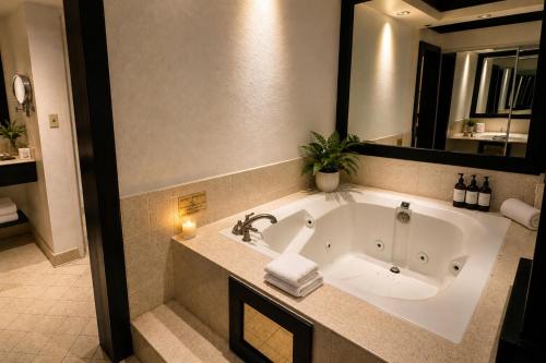 a bathroom with a large tub with a plant in it at Palette Las Vegas in Las Vegas