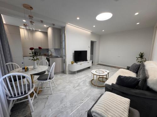 a living room with a couch and a table at Centro Apartamentai in Plungė