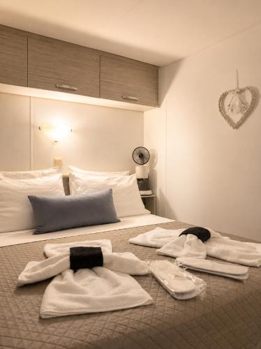 a bedroom with a bed with towels on it at Glykofilousa Tiny Ηouse in Petra