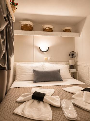 a bedroom with a bed with towels on it at Glykofilousa Tiny Ηouse in Petra