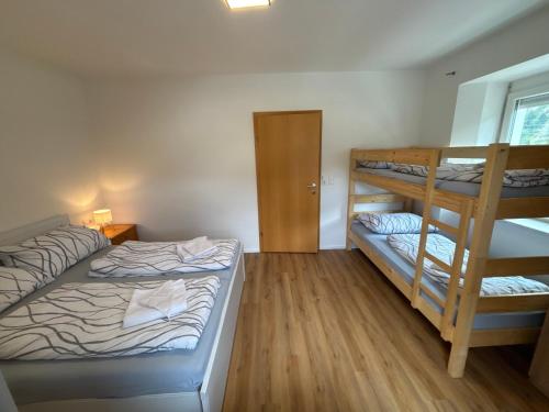 a bedroom with two bunk beds and a window at Anita Apartments in Flattach
