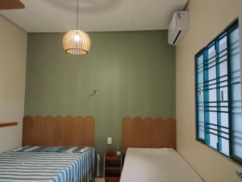 a bedroom with a bed and a large window at Solar da Colina in Petrolina