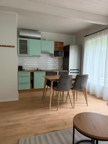 a kitchen with a table and chairs in a room at Nurmeveski Holiday House in Nurme