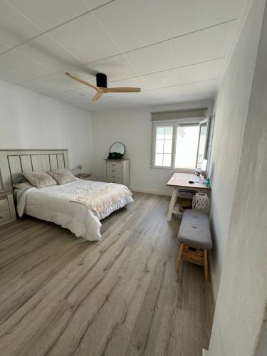 a bedroom with a bed and a ceiling fan at Casa Capereta in Alberique