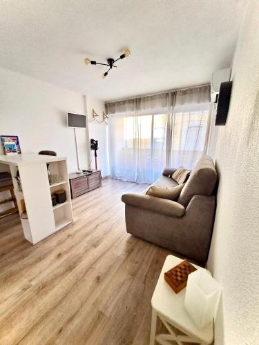 a living room with a couch and a table at BoHémian Studio in Sète Center in Sète