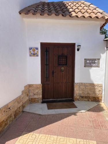 a door of a white house with a tile roof at Guest Wing at Casa Africa in Lorca