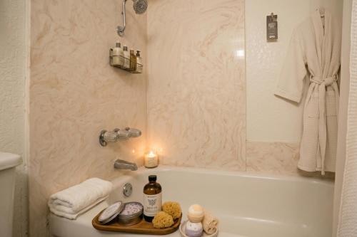 a bathroom with a bath tub and a candle on a tray at Collection O Las Vegas in Las Vegas