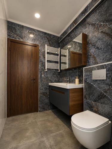 a bathroom with a toilet and a sink at phranta in Gonio