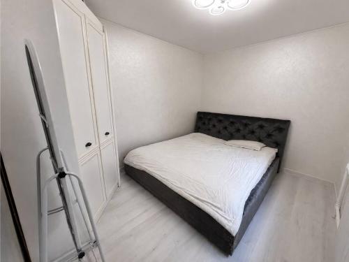 a small bedroom with a bed and a closet at Дом in Almaty