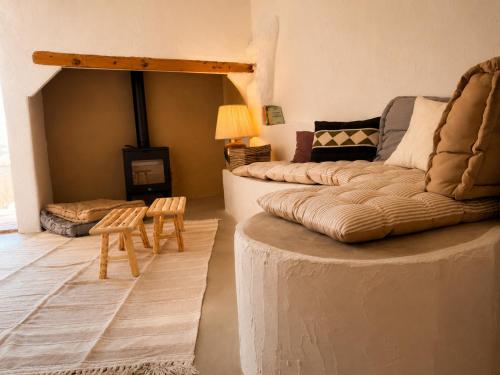 a living room with a couch and a fireplace at Casa do tio Frade in Aldeia do Mato