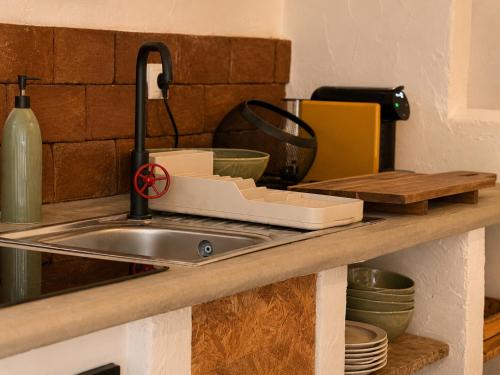 a kitchen counter with a sink next to a sink at Casa do tio Frade in Aldeia do Mato
