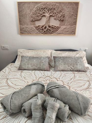 a bed with two pairs of shoes on top of it at El Refugio in Aracena
