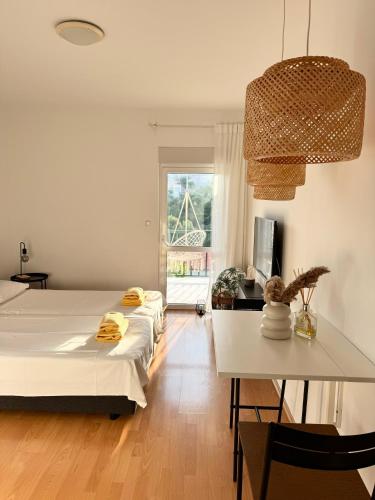 a room with four beds and a table and a window at Villa Knez in Trogir