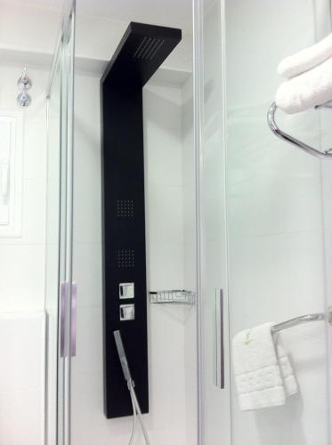 a shower with a glass door in a bathroom at Hotel Molinos in Granada