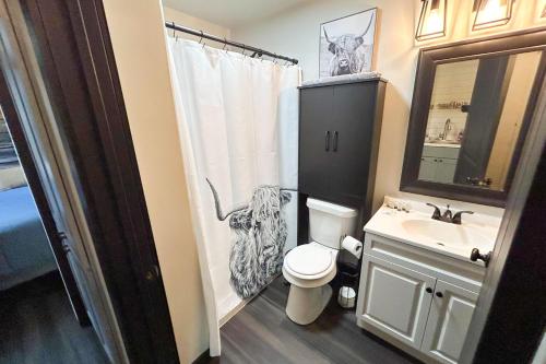 a bathroom with a toilet and a sink at Red Barn North - 40 in Mead