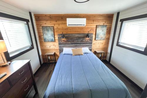a bedroom with a bed in a room with wooden walls at Red Barn North - 40 in Mead