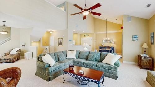 a living room with a couch and a ceiling fan at Bear Trap Dunes - 45D Willow Oak Ave in Ocean View
