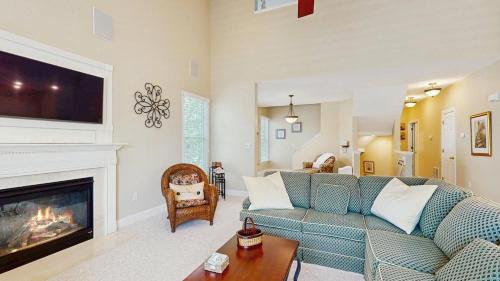 a living room with a couch and a fireplace at Bear Trap Dunes - 45D Willow Oak Ave in Ocean View