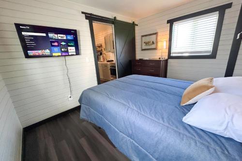 a bedroom with a bed and a tv on the wall at Red Barn South - 41 in Mead