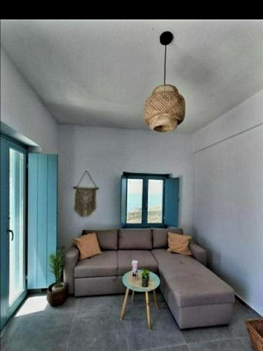a living room with a couch and a table at Ελαιόλιθοι Μάνη Villas 2 in Oitylo