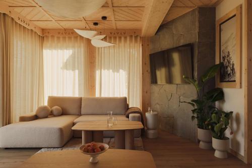 a living room with a couch and a table at Lovelia Luxury Chalet & Jacuzzi in Zakopane