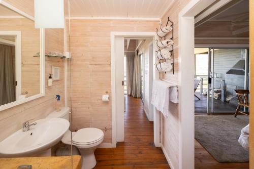 a bathroom with a toilet and a sink at Big Sky Cottages in Wolseley