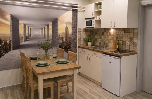 a kitchen and dining room with a table and chairs at Evergreen Residence VárLak in Debrecen