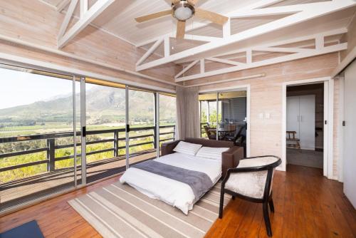 a bedroom with a bed and large windows at Big Sky Cottages in Wolseley