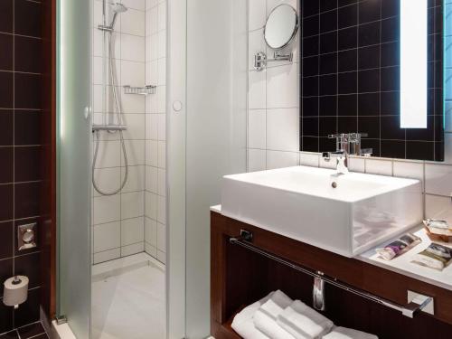 a bathroom with a sink and a shower at Mercure Ostrava Center in Ostrava