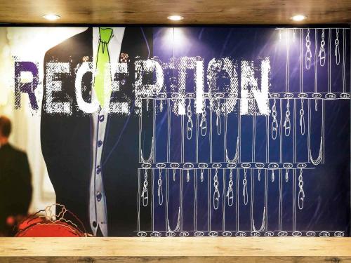 a window with a suit and tie and the word return at ibis budget Belfast City Centre in Belfast