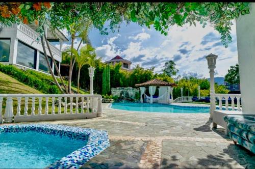 a backyard with a swimming pool and a gazebo at The Butterfly Mansion in Envigado