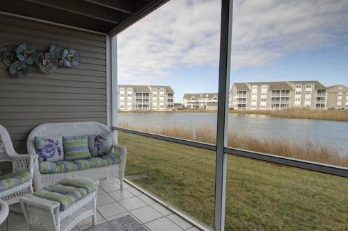 a screened in porch with a view of the water at 30399 Pavilion Dr, #1301, Ocean View in Ocean View