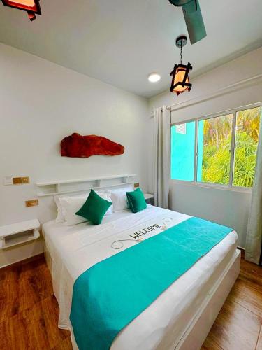 a bedroom with a large bed with a large window at Island Luxury Dive Hotel - Fulhadhoo in Fulhadhoo