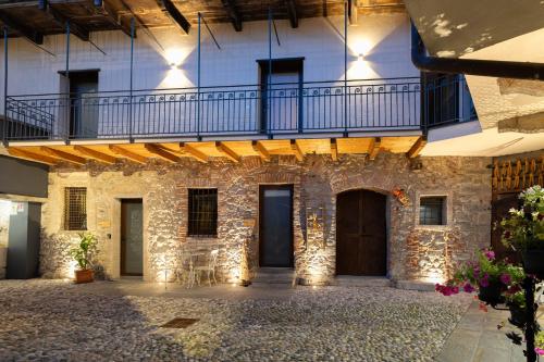 a stone building with a balcony on top of it at Antica corte in Zogno