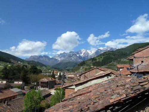 a view of a village with mountains in the background at Apartamentos Casa de la Abuela in Potes