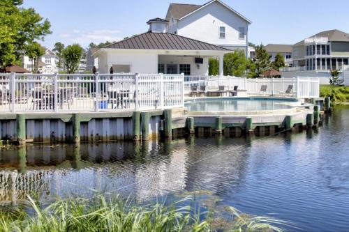 a house with a dock on a body of water at 36967 S. Silver Sands Dr, Bethany Beach in Bethany Beach