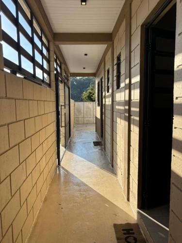 an empty hallway of a building with a window at Vila Chacrinha apartamento 2 in Campo Limpo