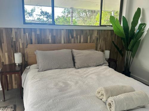 a bedroom with a bed with two towels on it at The Hunter Studio in Cessnock