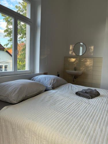 a bedroom with a bed with a sink and a window at MartiniRoom Signature in Glauchau