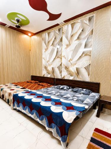 a bedroom with a bed with blue and white at Maa janki paying guest house near Ram mandir in Ayodhya